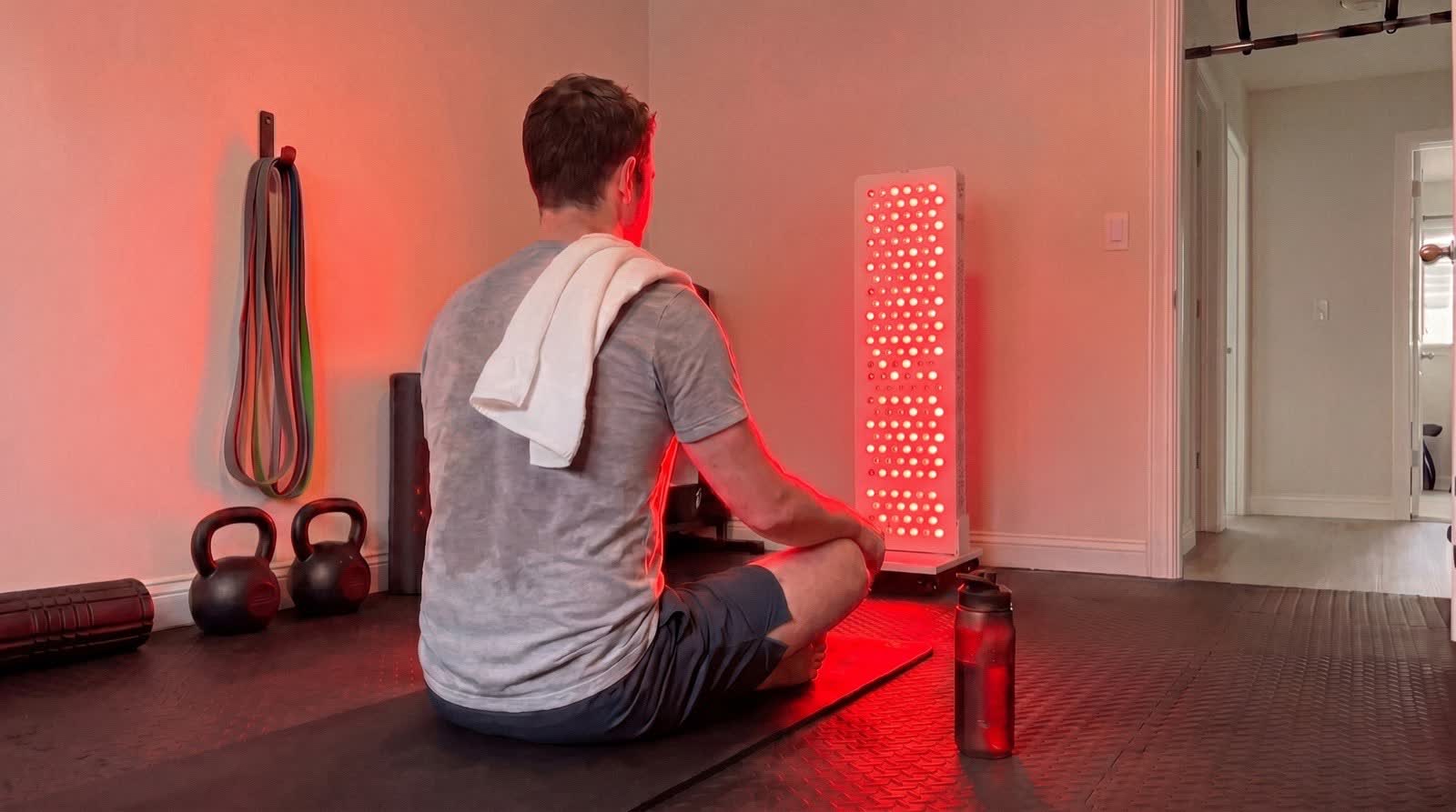 Athlete recovering post-workout next to the panel on its stand
