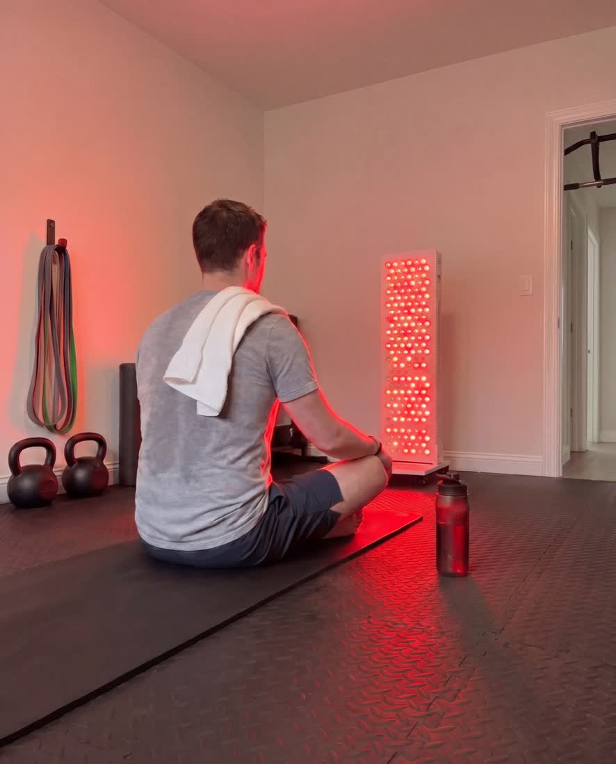 Athlete recovering post-workout next to the panel on its stand
